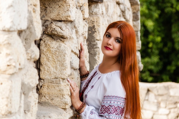 Beautiful girl in Ukrainian embroidered and red skirt