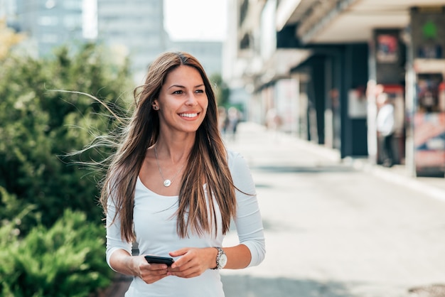 Beautiful girl walking in the city street.