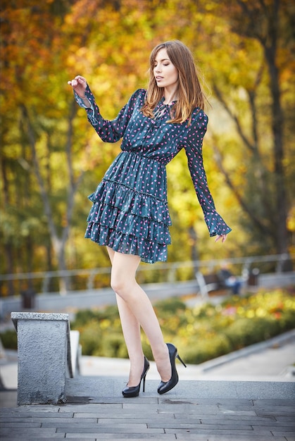 Beautiful girl walking in the park in autumn