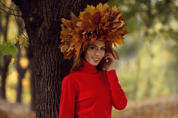 Beautiful girl walking in the park in autumn