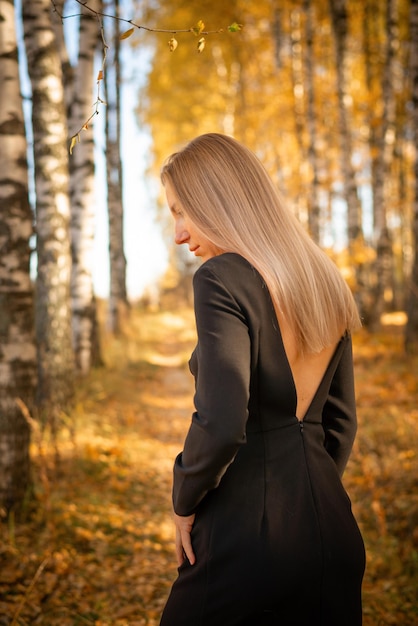 A beautiful girl walks in an autumn park