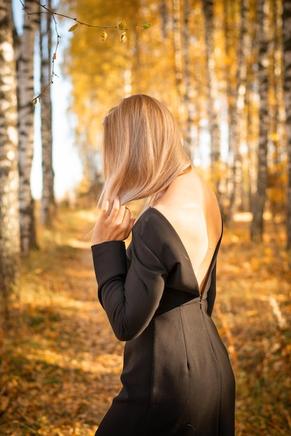 A beautiful girl walks in an autumn park