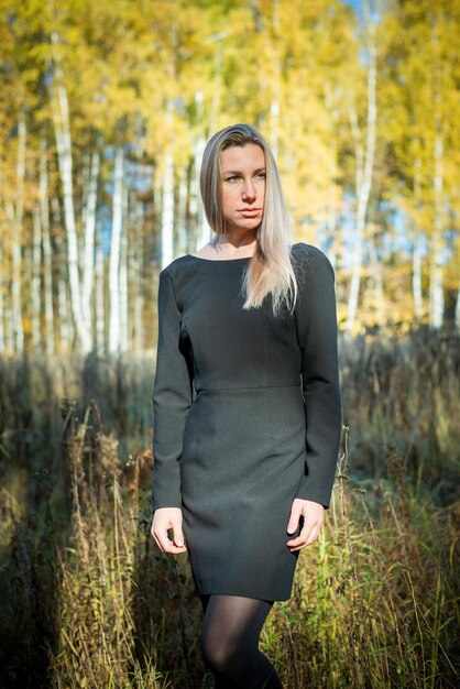 A beautiful girl walks in an autumn park