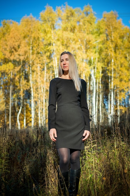 A beautiful girl walks in an autumn park