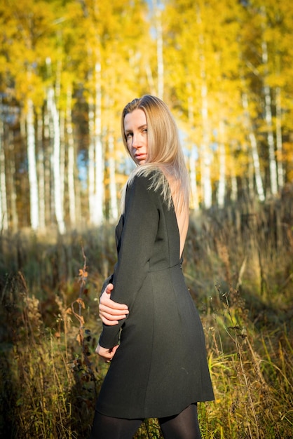 A beautiful girl walks in an autumn park