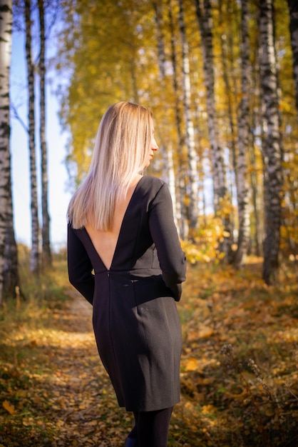 A beautiful girl walks in an autumn park