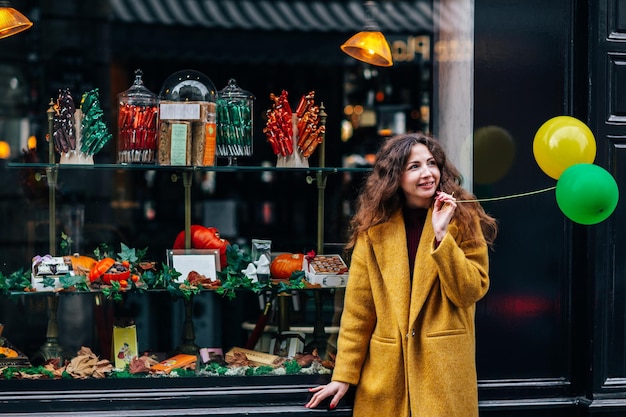 A beautiful girl walks the streets of Paris and looks at the beautiful New Years windows