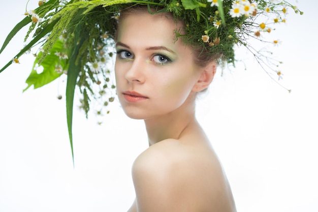 Beautiful girl wearing a wreath of wildflowers