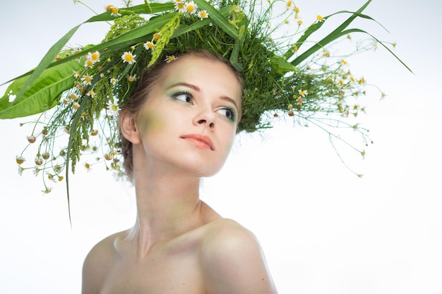 Beautiful girl wearing a wreath of wildflowers