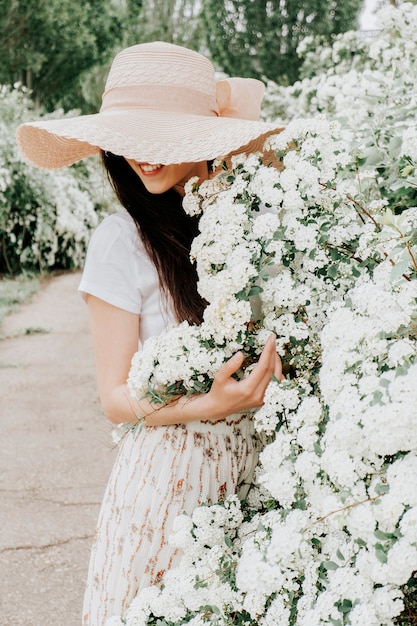 Beautiful girl on a white background of flowers.