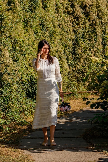 Beautiful girl in a white dress in the park