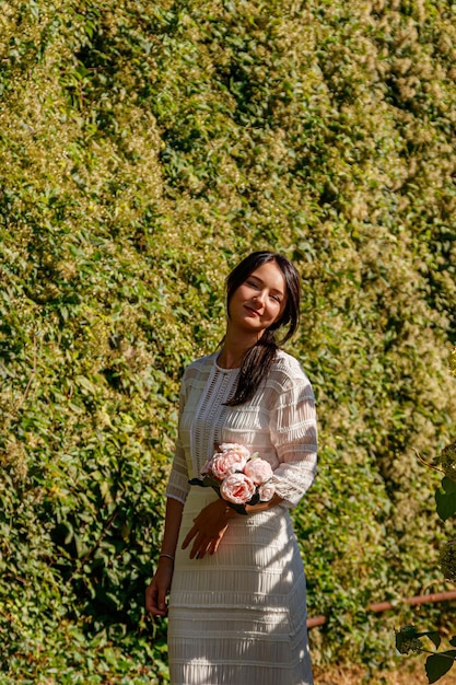 Beautiful girl in a white dress in the park