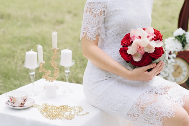 beautiful girl in a white dress with a bouquet of flowers