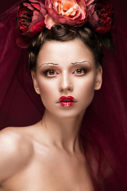 Beautiful girl with art creative makeup in image of red bride for Halloween Beauty face