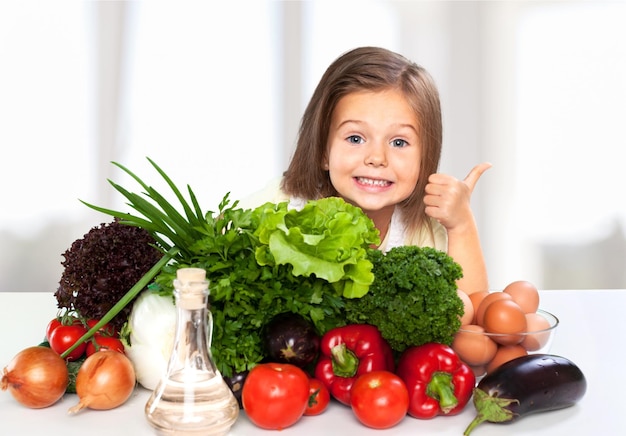 Beautiful girl with colored vegetables showing thumbs up