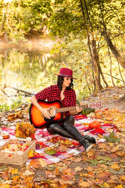 Beautiful girl with a guitar on a background