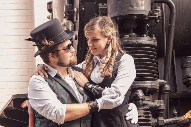 Beautiful girl with a guy couple in love in steampunk clothes