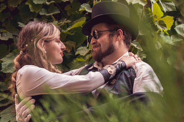 Beautiful girl with a guy couple in love in steampunk clothes