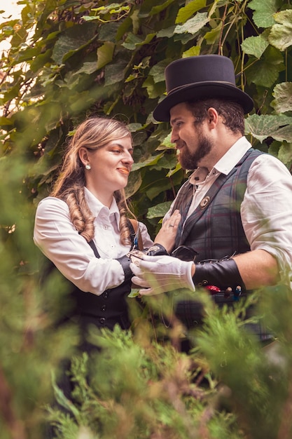 Beautiful girl with a guy couple in love in steampunk clothes