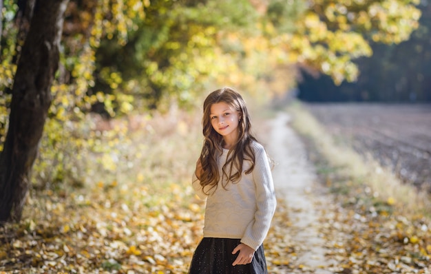 beautiful girl with long hair on a forest path