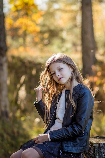 beautiful girl with long hair sitting on nature