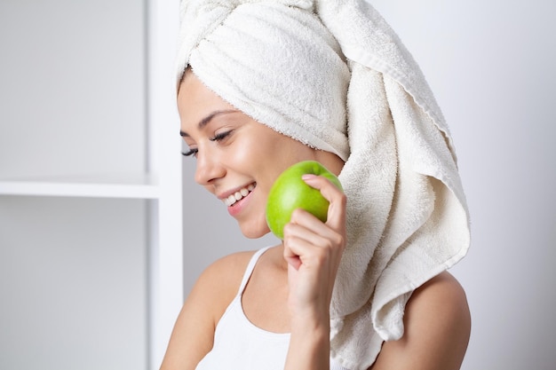 Beautiful Girl With Perfect White Teeth Holding Green Apple Smiling