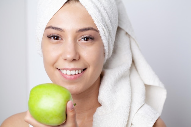 Beautiful Girl With Perfect White Teeth Holding Green Apple Smiling