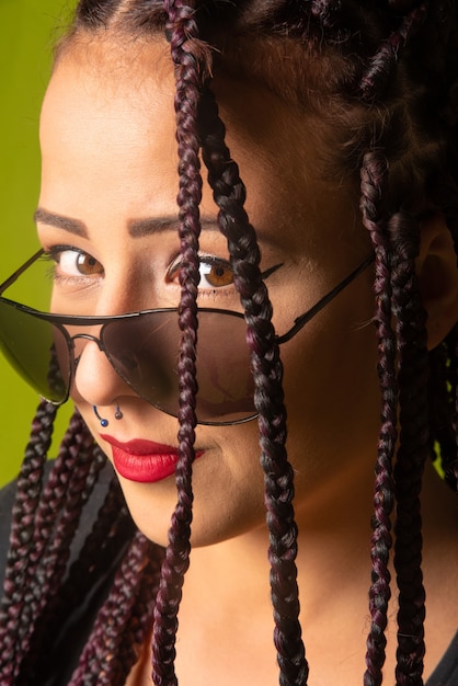 Beautiful girl with pigtails in her hair and sunglasses