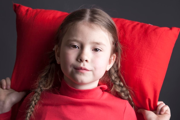 Beautiful girl with pigtails wants to sleep