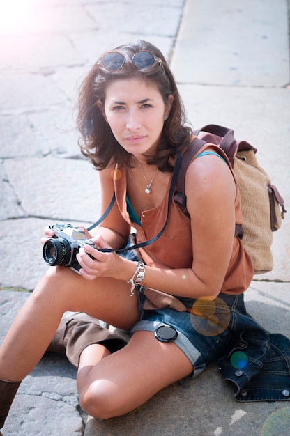 beautiful girl with scarf and camera on the lawn