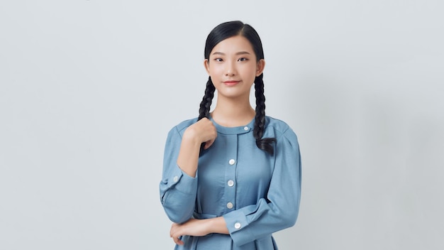 Beautiful girl with two braids in a blue shirt