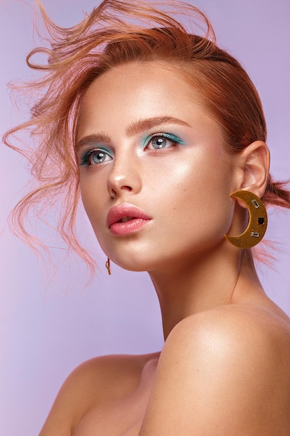 Beautiful girl with unusual accessories and makeup on a bright background Beauty face