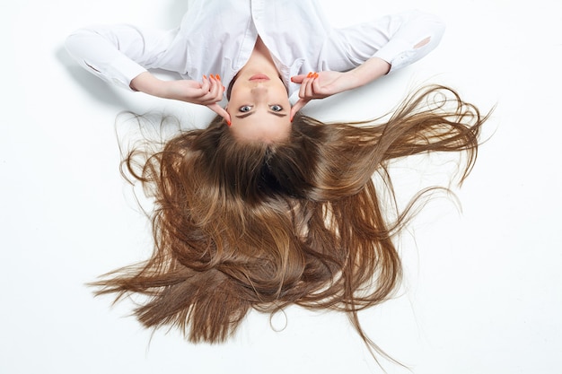 Beautiful girl with very long hair on a white background