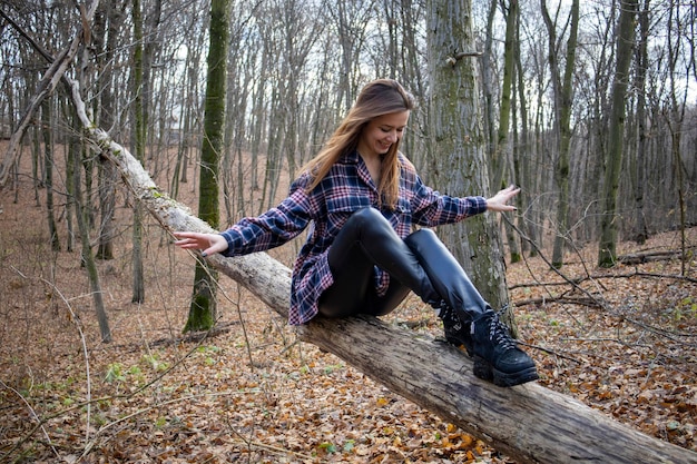 Beautiful girl in the woods near the trees