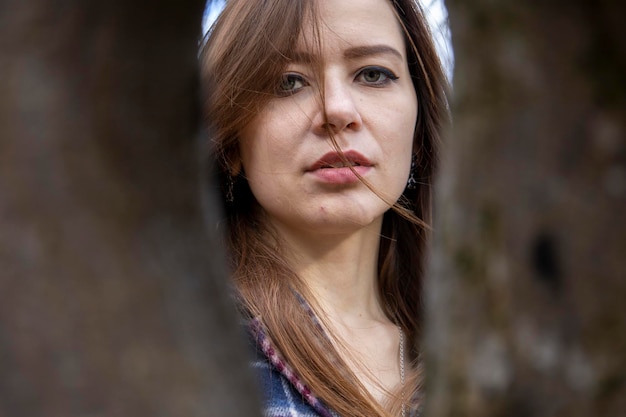 Beautiful girl in the woods near the trees