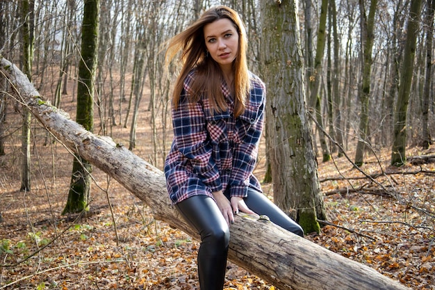 Beautiful girl in the woods near the trees