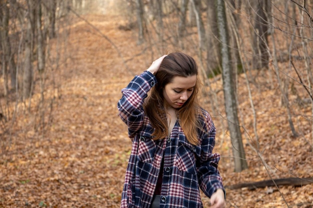 Beautiful girl in the woods near the trees