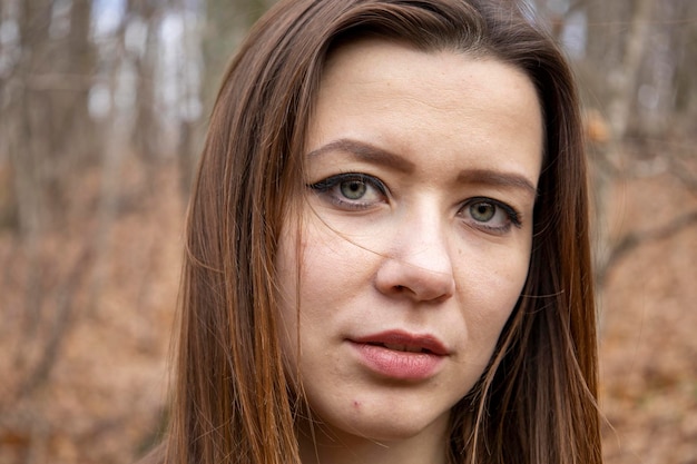 Beautiful girl in the woods near the trees