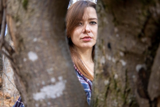 Beautiful girl in the woods near the trees