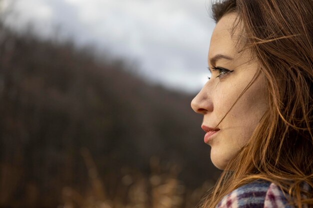 Beautiful girl in the woods near the trees