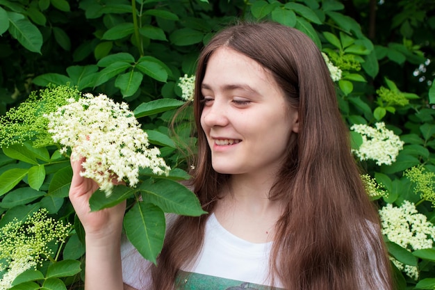 Beautiful girl  years old with long hair and an elder tree