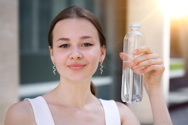 beautiful girl young thirsty woman is drinking pure fresh water from bottle