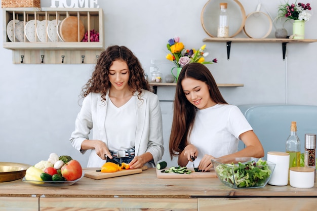 Beautiful girls cooking delicious, wholesome food in the kitchen