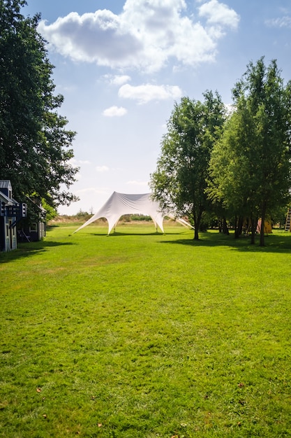 Beautiful green lawn for relaxation, green area with awning