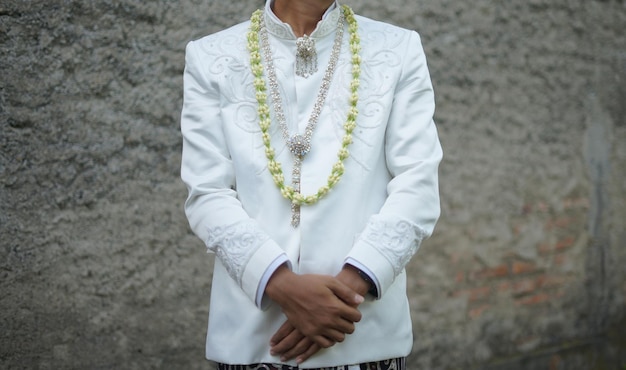 Beautiful Groom Holding Hand while Wearing Wedding Dress with Jasmine and Magnolia Flower Necklace f