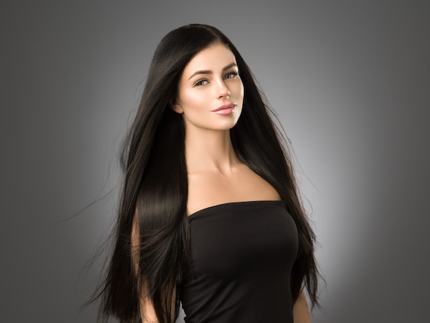 Beautiful hair woman with long brunette beauty helathy hairstyle female portrait. Studio shot.