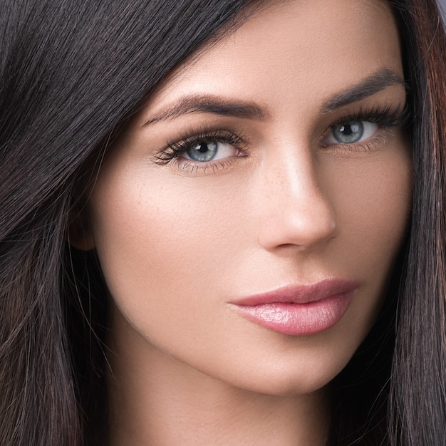 Beautiful hair woman with long brunette hairstyle. Studio shot.