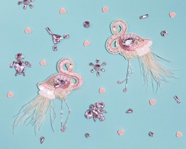 Beautiful handmade gentle pink flamingos brooches with crystals feathers and roses flat top view