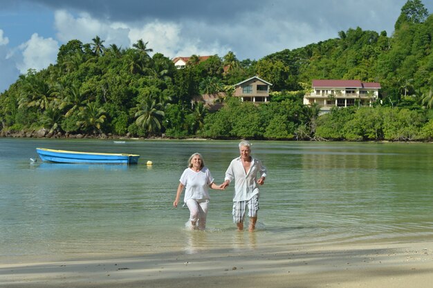 Beautiful happy elderly couple rest at tropical resort