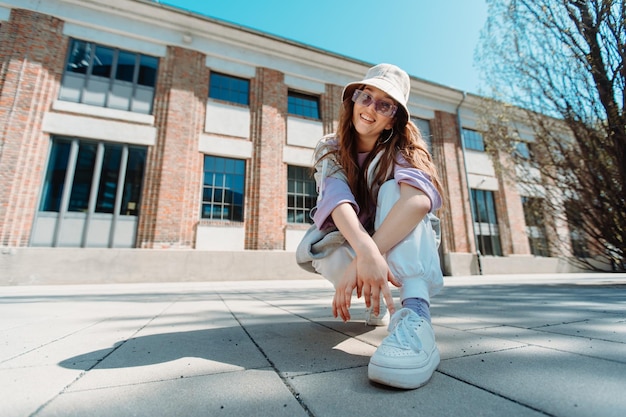 Beautiful and happy European girl having fun dancing break dance hip hop freestyle outdoors